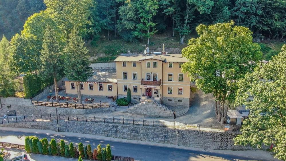 an aerial view of a large yellow house with trees at Willa Agnieszki in Jagniątków