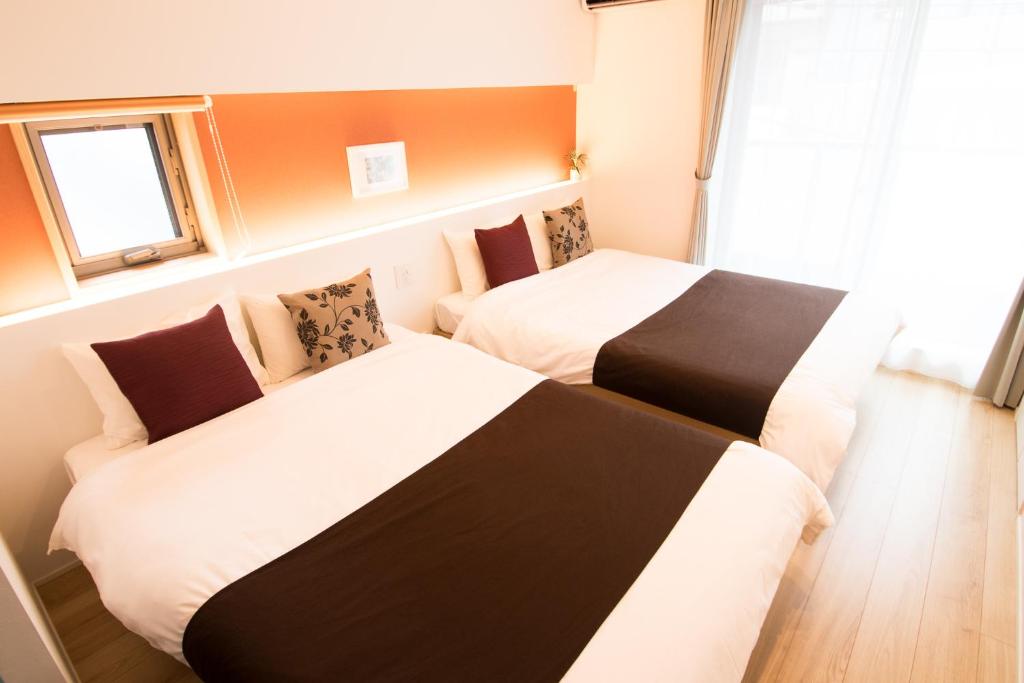 Postel nebo postele na pokoji v ubytování Apartment Hotel Tenjin TUMUGU