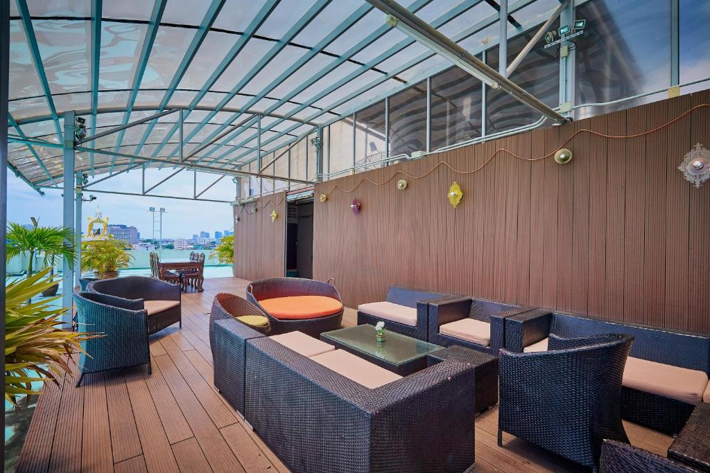 a restaurant with chairs and tables in a building at Sivalai Place in Bangkok