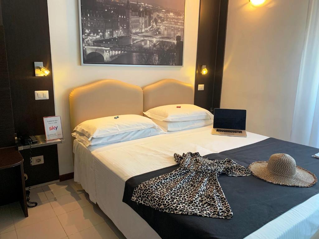 Postel nebo postele na pokoji v ubytování Hotel Perugino