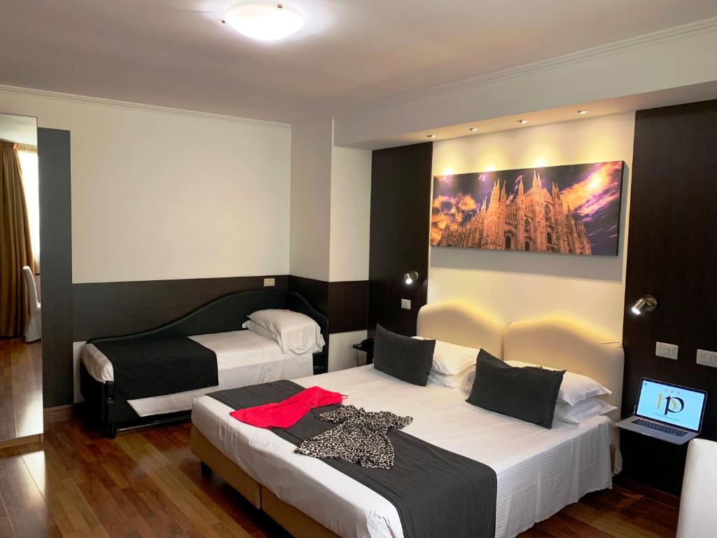 Postel nebo postele na pokoji v ubytování Hotel Perugino
