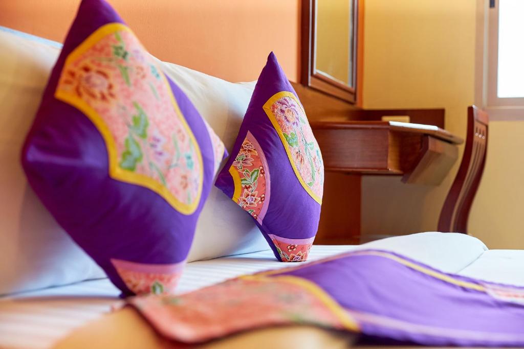 two pillows sitting on top of a bed at Sivalai Place in Bangkok