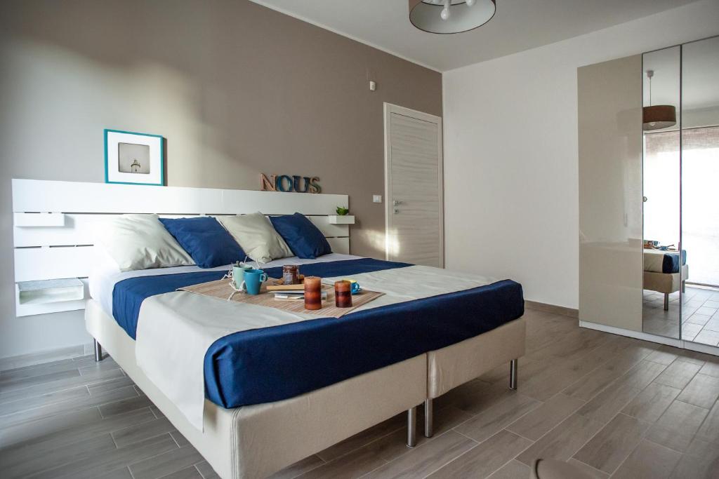 a bedroom with a large bed with a tray on it at Quality Apartment Parisina in Pescara