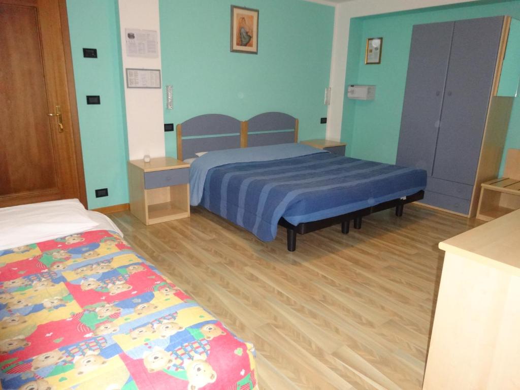 Postel nebo postele na pokoji v ubytování Hotel Genzianella