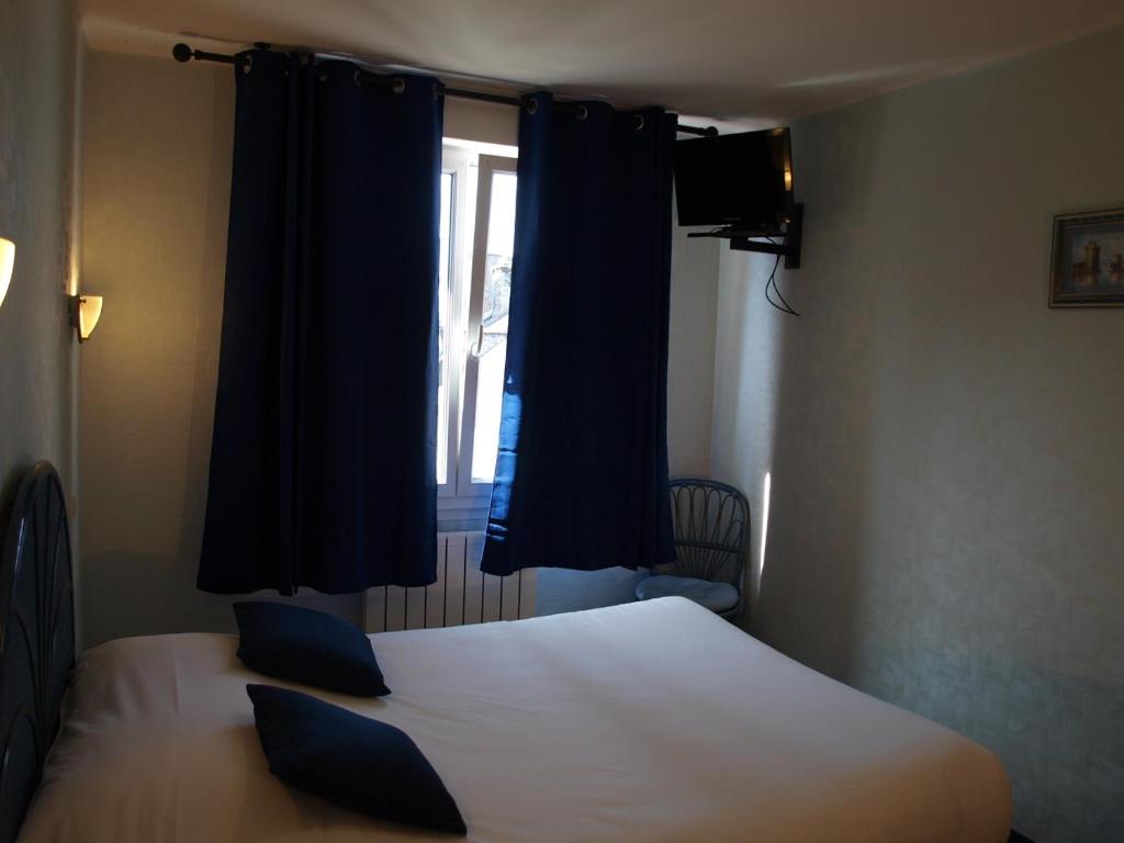 Postel nebo postele na pokoji v ubytování Hôtel des îles