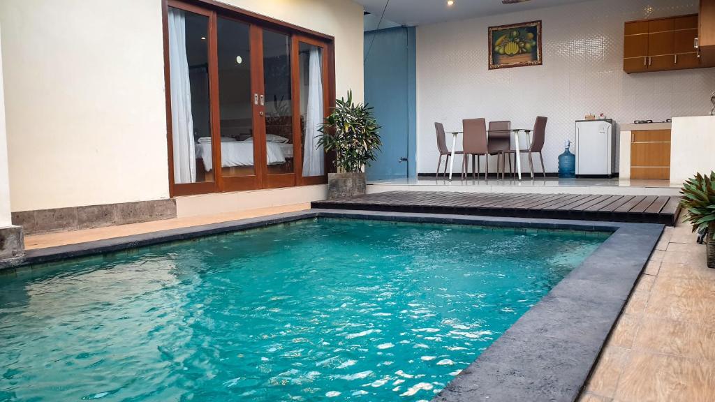 a swimming pool in the middle of a house at The Bagus in Kerobokan
