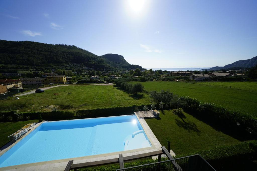 a swimming pool in the middle of a green field at GardaGulf EdenGarden in Garda