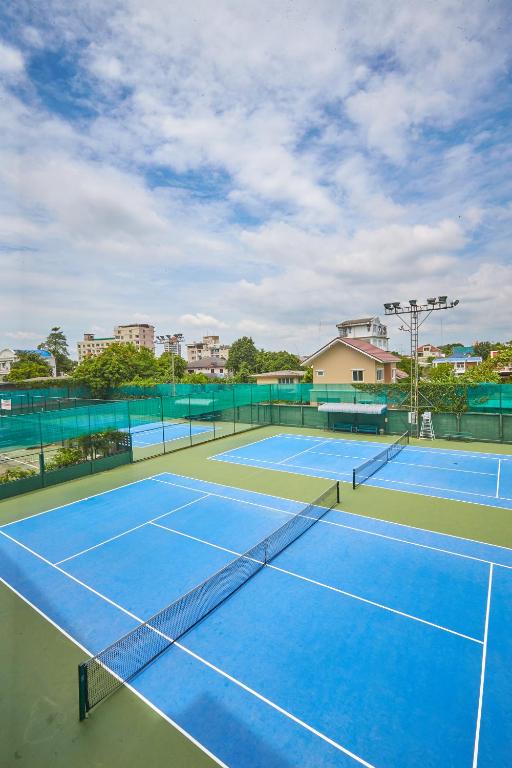 a tennis court with two tennis courts at Sivalai Place in Bangkok