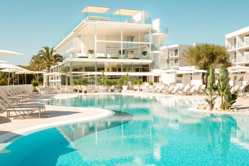 a swimming pool in front of a building at Monsuau Cala D'Or Hotel 4 Sup - Adults Only in Cala d´Or