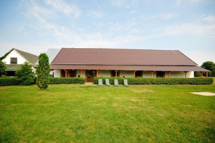 a house with a large yard in front of a building at Gergely Tanya in Garabonc