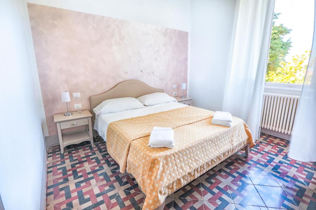 Postel nebo postele na pokoji v ubytování Tenuta Villa Colle Sereno