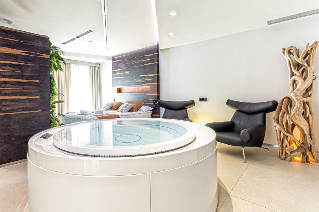 a living room with a glass table and chairs at Costa Rica Bibione SPA in Bibione