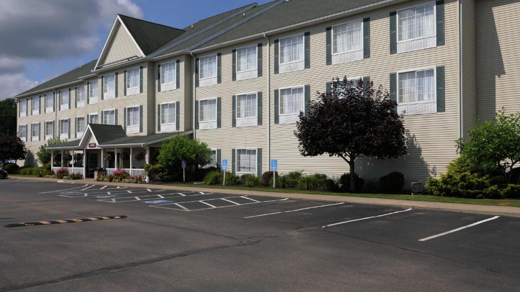 a large building with a parking lot in front of it at Coshocton Village Inn & Suites in Coshocton
