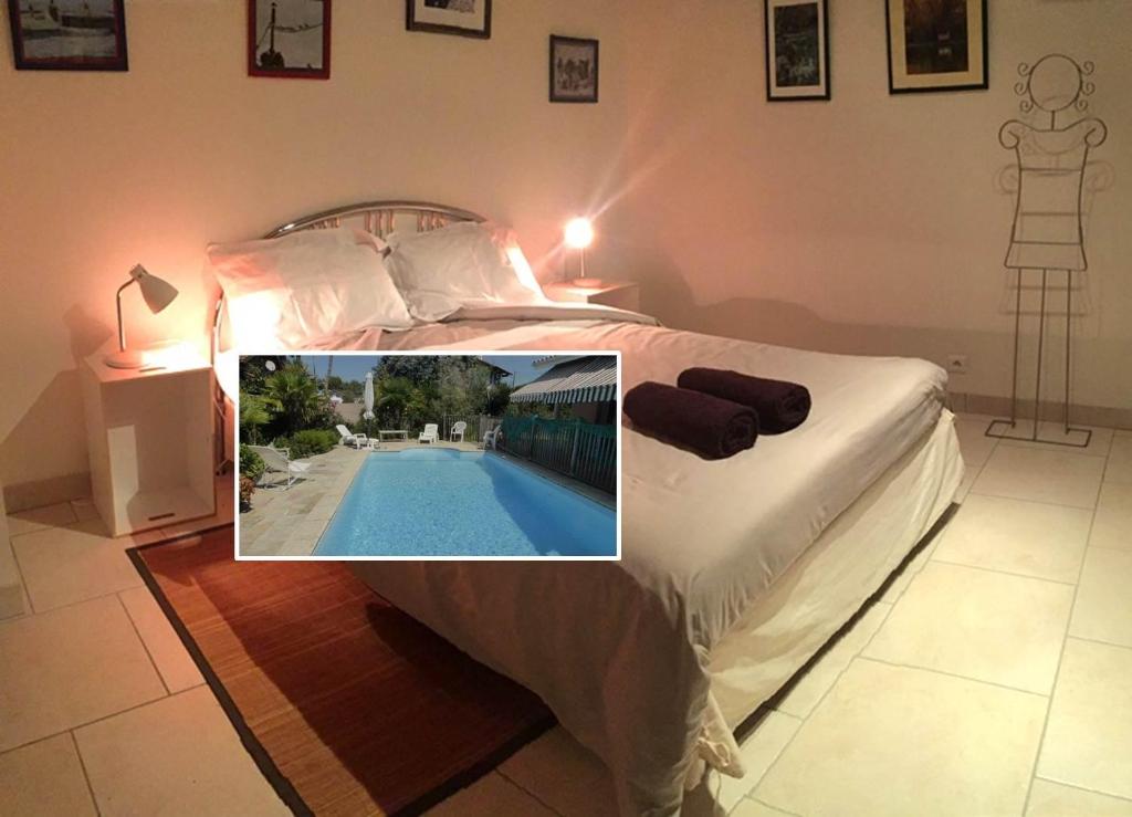 a picture of a bedroom with a swimming pool at Villa Orion in Capbreton