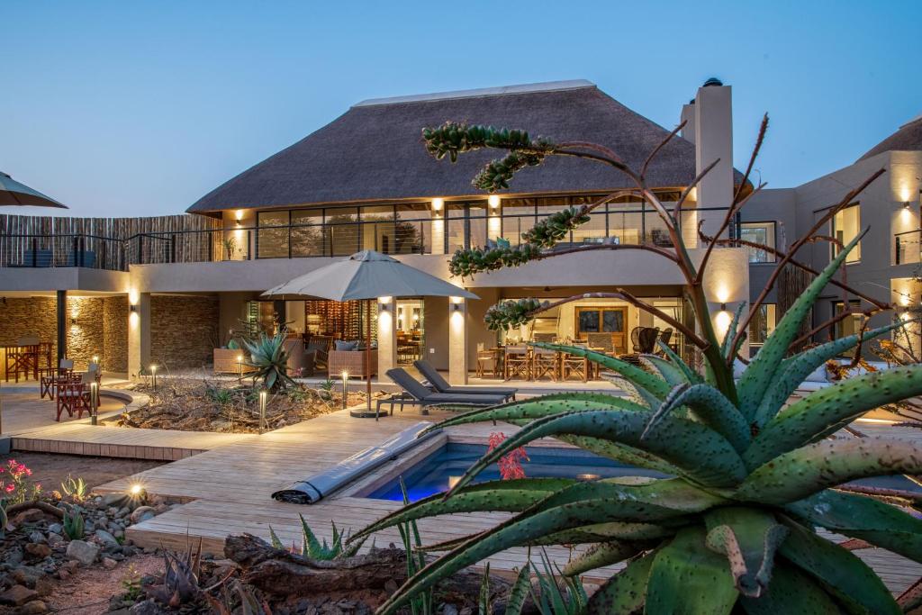 a large house with a swimming pool in front of it at Elephant Point in Skukuza