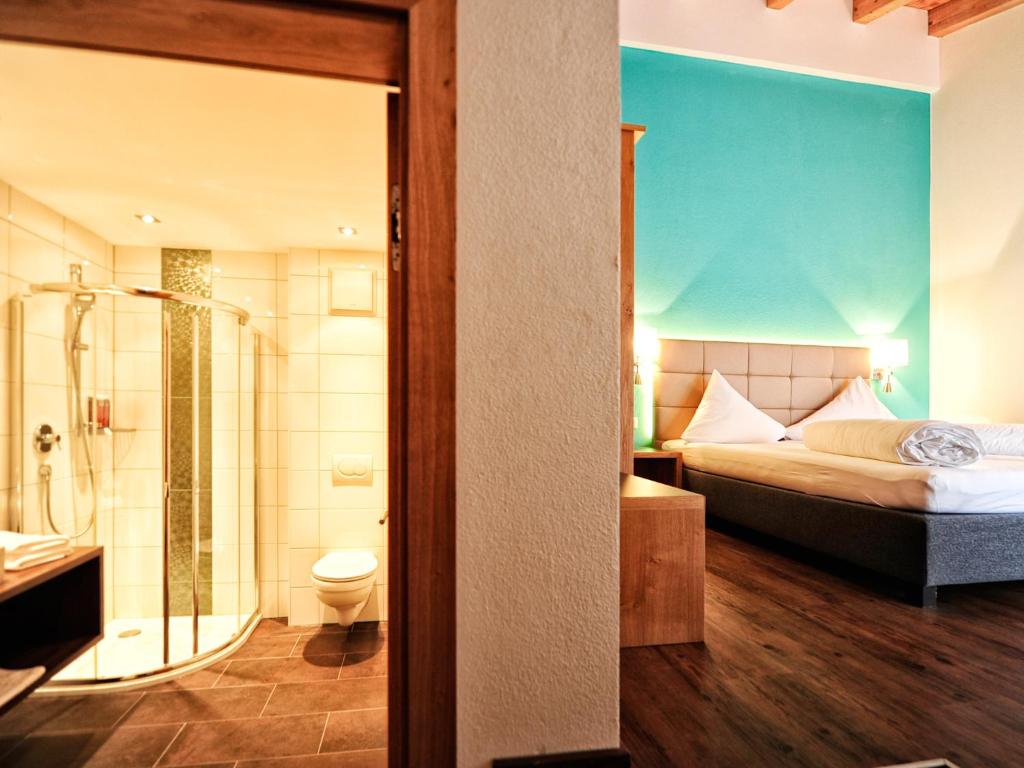 Postel nebo postele na pokoji v ubytování Hotel Garni Alpenland