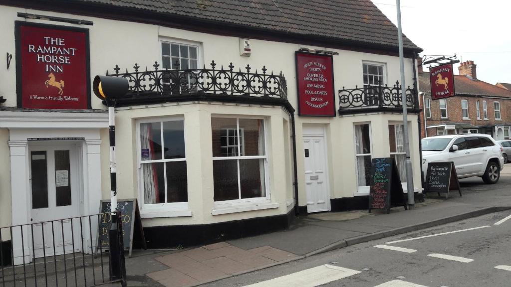 a building on the corner of a street at The Rampant Horse Public House in Fakenham