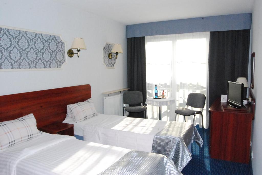 Postel nebo postele na pokoji v ubytování Amigo Hotel