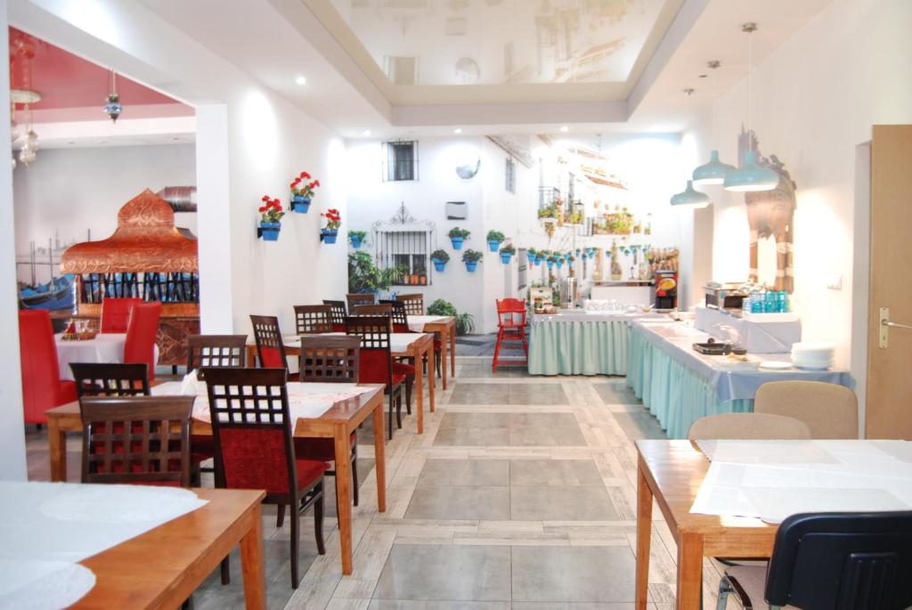 a restaurant with wooden tables and chairs and a counter at Amigo Hotel in Sulejówek