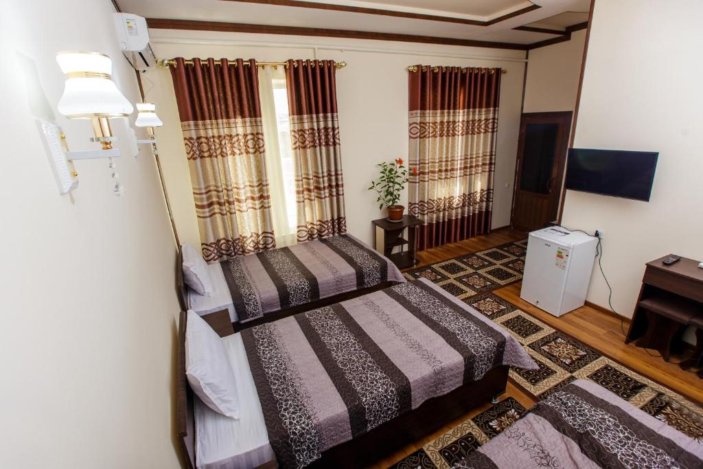 Posteľ alebo postele v izbe v ubytovaní Xurshidabonu Guest House