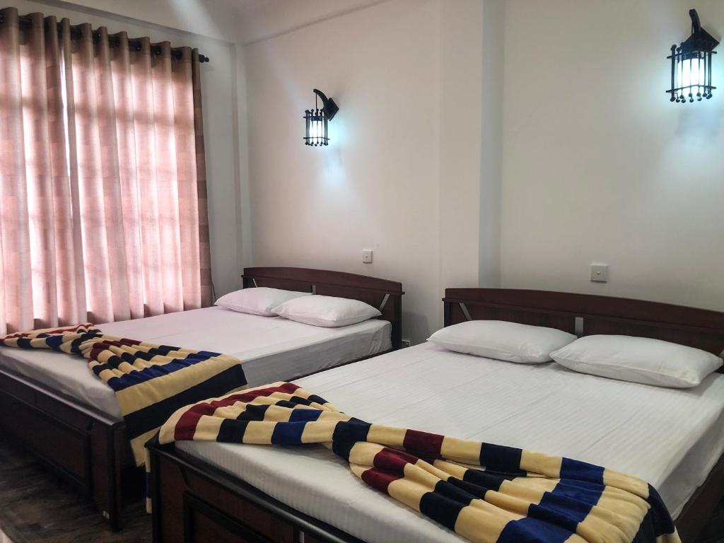 Postel nebo postele na pokoji v ubytování Gimhana Guest House