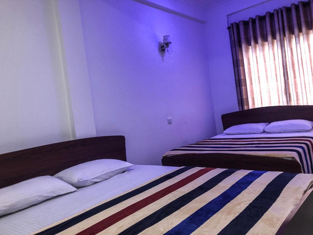 Postel nebo postele na pokoji v ubytování Gimhana Guest House