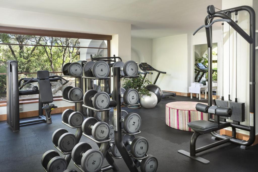 a fitness room with a bunch of clocks and a gym at Hotel Abi d'Oru in Porto Rotondo