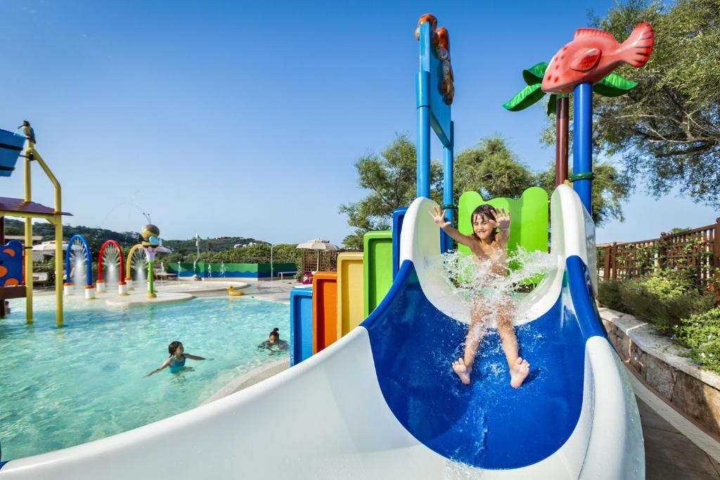 a young girl on a slide at a water park at Hotel Abi d'Oru in Porto Rotondo