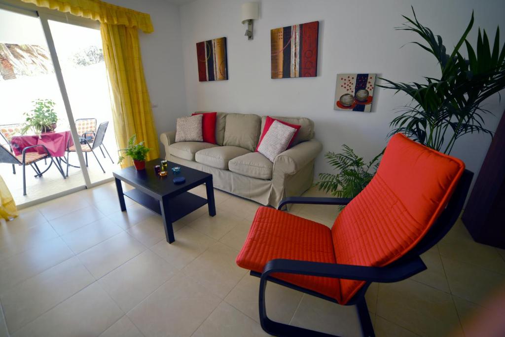 a living room with a couch and a chair and a table at Casa Lola in Agaete