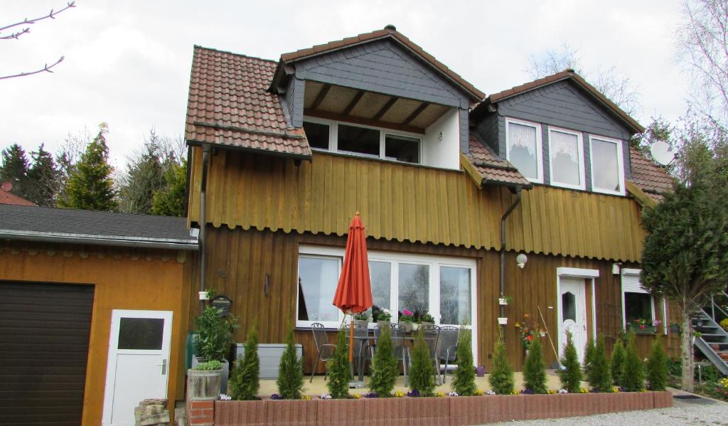 a house with a red umbrella in front of it at Schau ins Land in Elbingerode