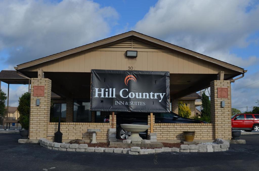 a building with a sign on the front of it at Hill Country Inn and Suite in Copperas Cove