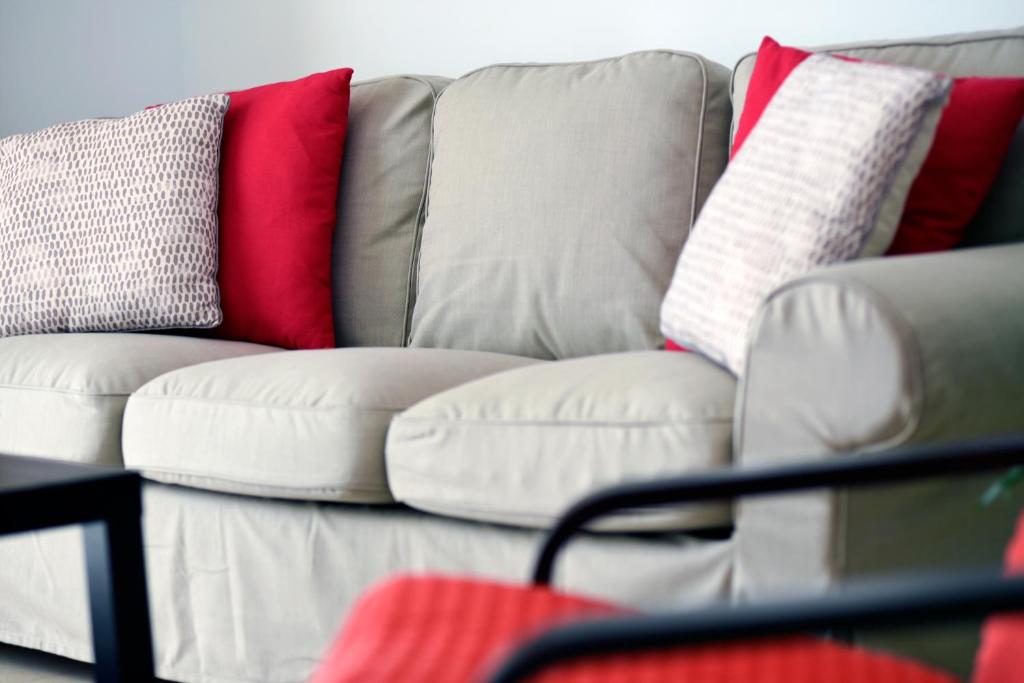 a white couch with different colored pillows on it at Casa Lola in Agaete
