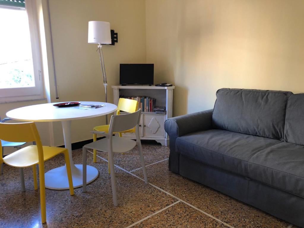 a living room with a couch and a table and chairs at LIGURIA HOLIDAYS - "La Casa di Gisella" in Camogli