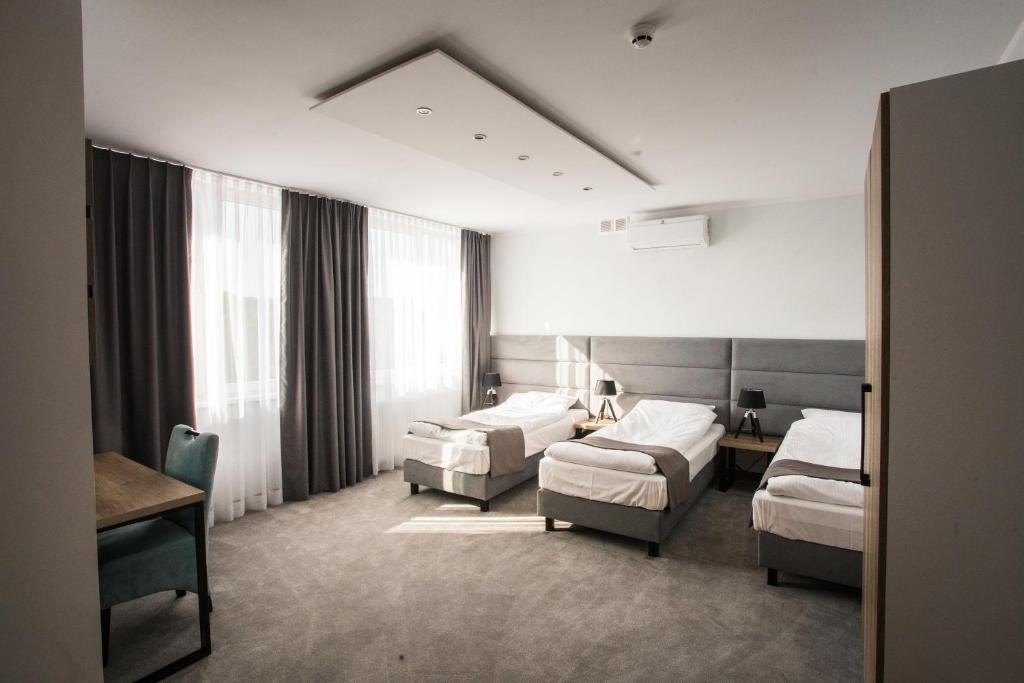 Hotel Tiffany tesisinde bir odada yatak veya yataklar