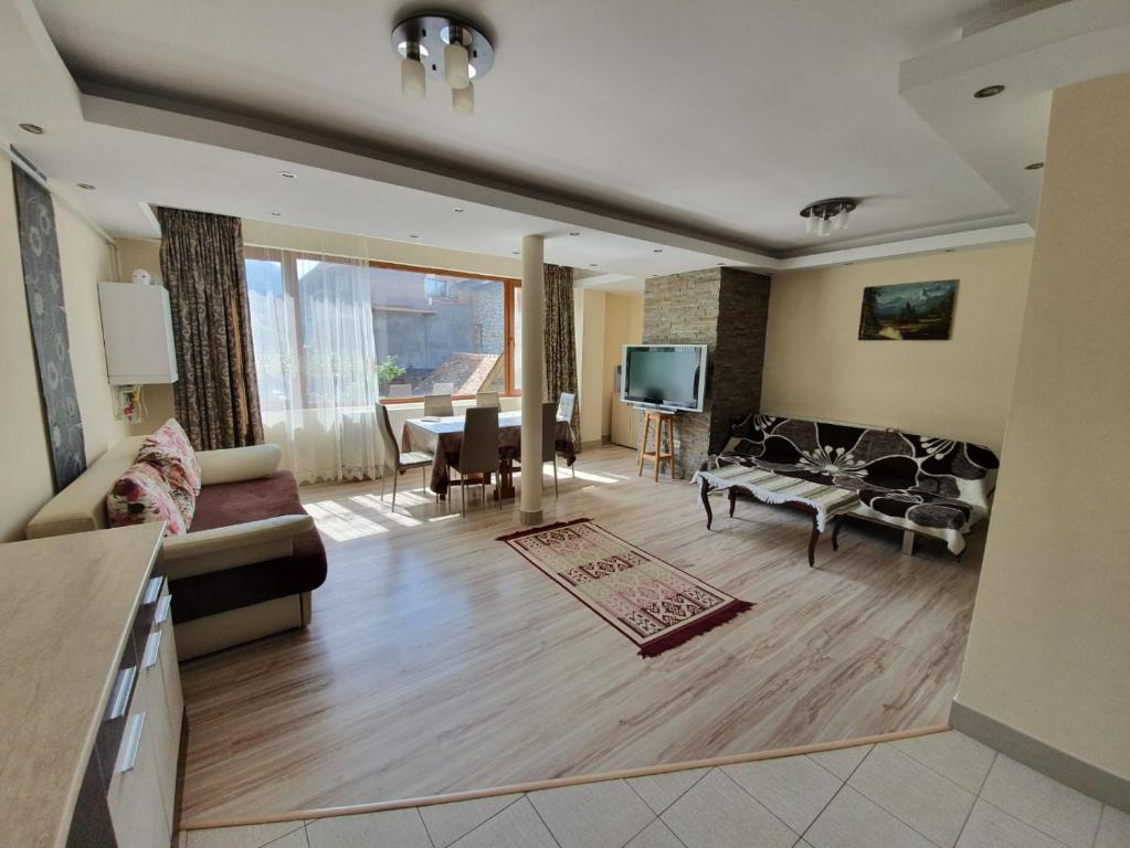 a living room with a couch and a table at Montana View in Poiana Brasov