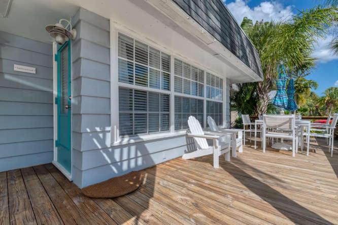 a porch of a house with a wooden deck at Buttonwood Cottage in Siesta Key