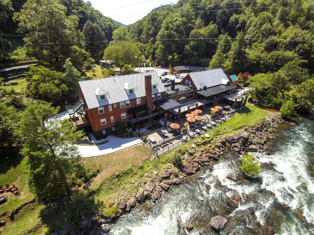 an aerial view of a house next to a river at Historic Tapoco Lodge in Tapoco