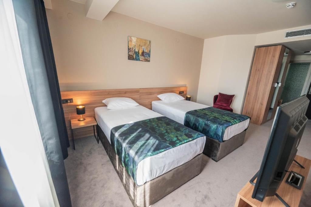 Postel nebo postele na pokoji v ubytování Hotel Aloha