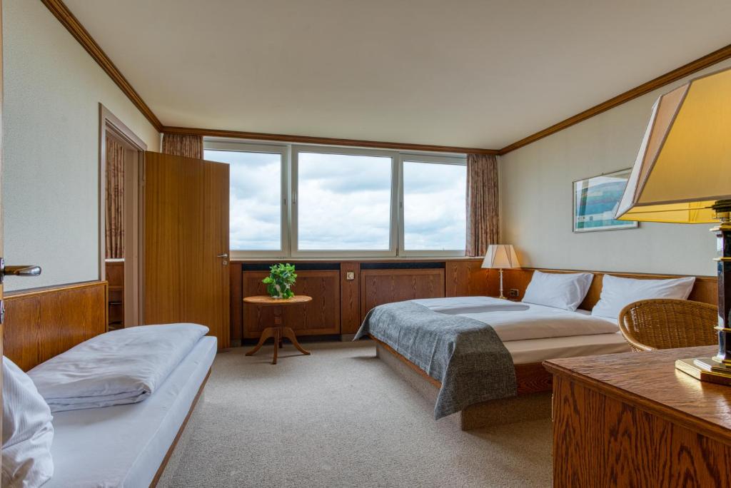 Postel nebo postele na pokoji v ubytování FF&E Hotel Dania