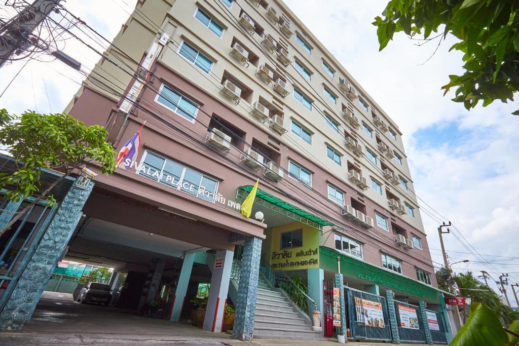 a large building with a staircase in front of it at Sivalai Place in Bangkok