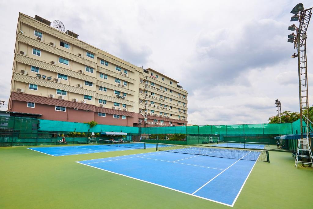 a tennis court in front of a large building at Sivalai Place in Bangkok