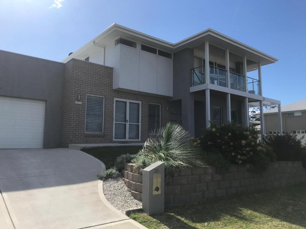 a large house with a driveway in front of it at Broughton Views in Corlette