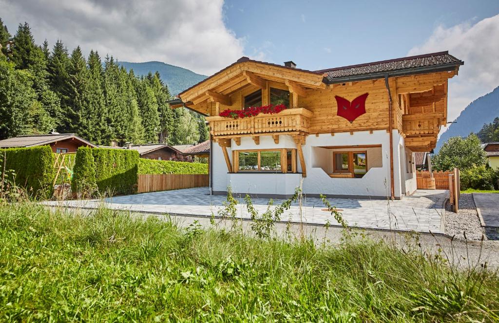 a wooden house with a red star on it at Chalet Fuchsbau in Viehhofen