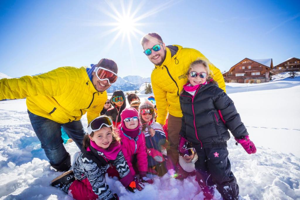 a group of people standing in the snow at Hôtel Club mmv Les Bergers **** in L'Alpe-d'Huez