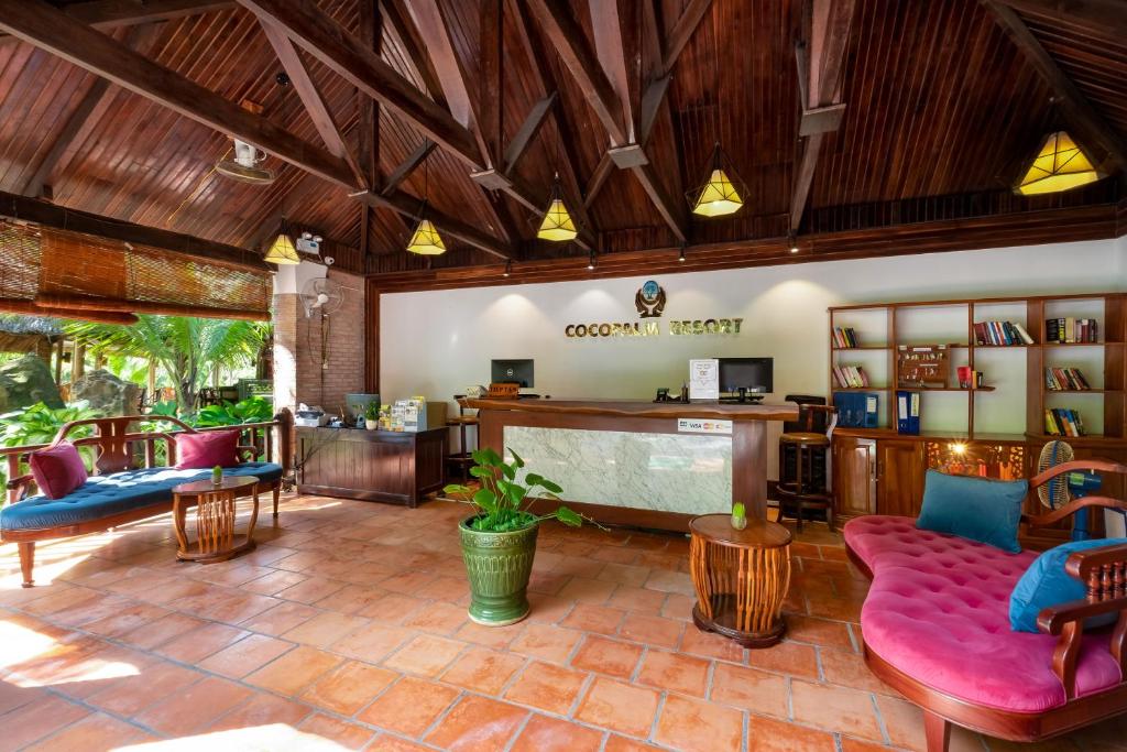 a living room with a couch and a table at Coco Palm Beach Resort & Spa in Phú Quốc