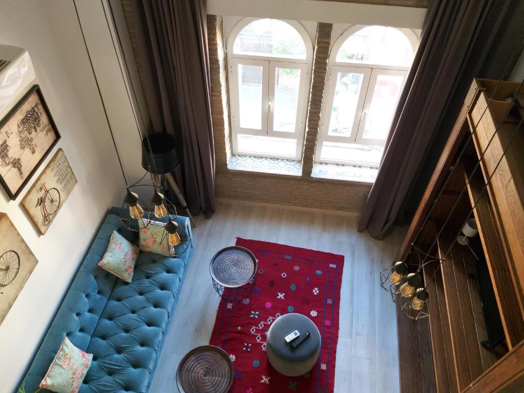 vista sul soffitto di un soggiorno con divano blu di GoToSeville FERIA APARTMENTS a Siviglia