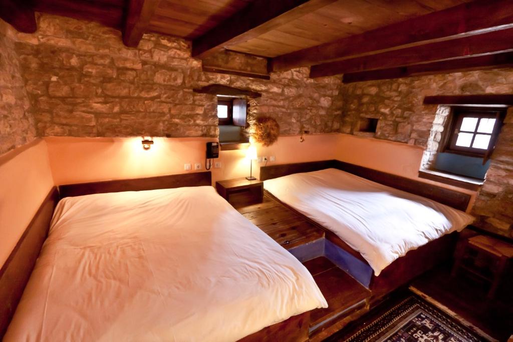 A bed or beds in a room at Arhontiko Aristis