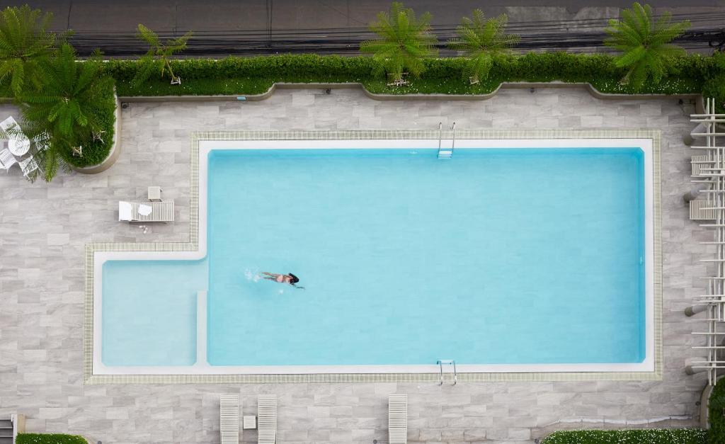 a person swimming in a large swimming pool at BU Place Hotel in Bangkok