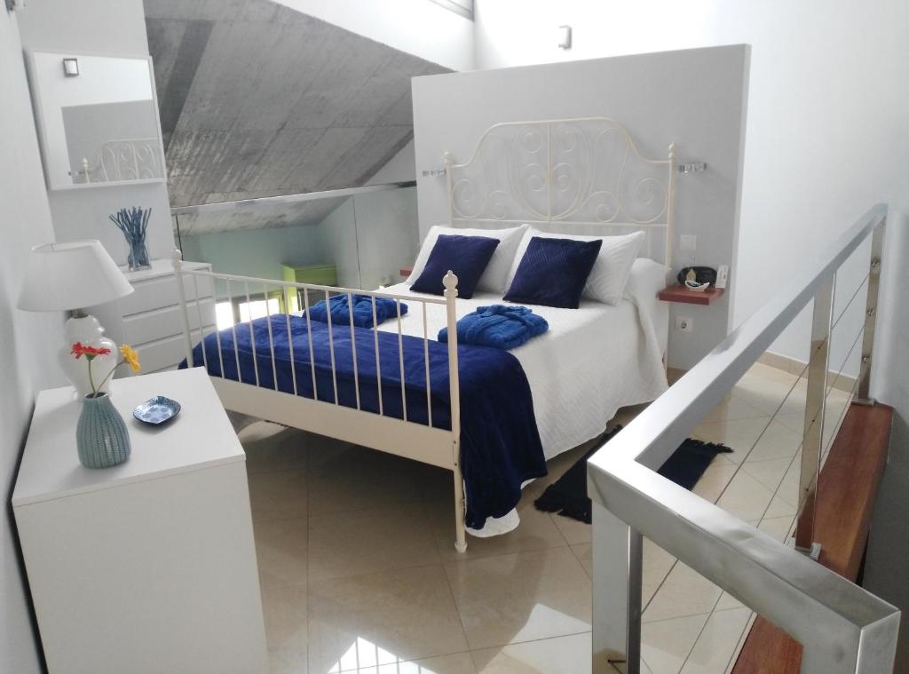 a bedroom with a bed with blue pillows and a staircase at Loft LUMINOSO San Juan in Telde