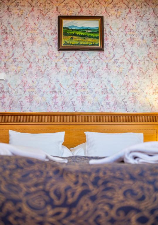 Postel nebo postele na pokoji v ubytování Borhotel Sziluett Farkasmály